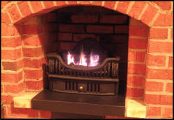 Coal Grates in new low cut front complete the small fireplace and being gas vent free they will heat!